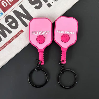Porte-clés de pickleball rose pastel pour joueuse, faces avant et arrière.