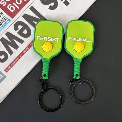 Porte-clés de pickleball vert citron fluorescent, détails des deux faces.